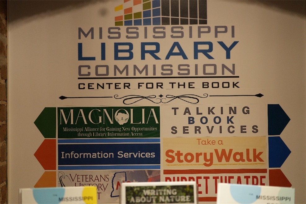 Poster showing Mississippi Library Commission Center for the Book with sections labeled Magnolia, Talking Book Services, StoryWalk, and Puppet Theatre.